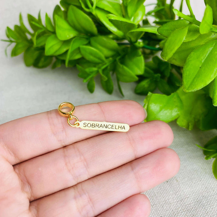 Berloque Plaquinha Sobrancelha dourado — detalhe da peça Work Semijoias